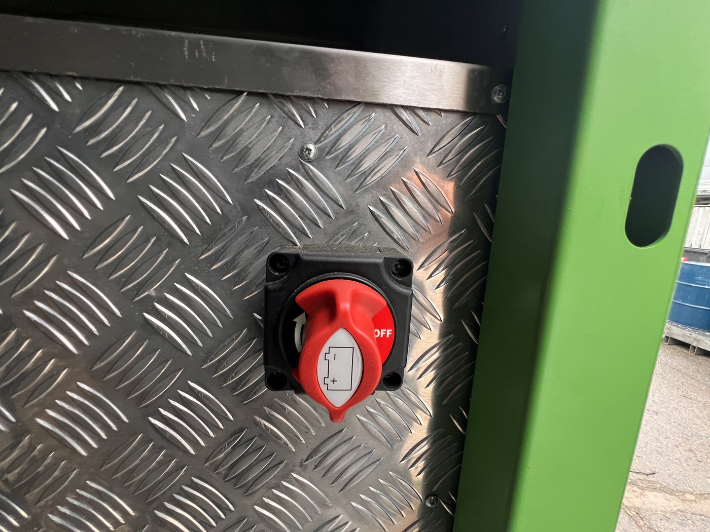 Fig. 16 — The cabin main isolator: a red rotary battery disconnect switch mounted on the chequerplate panel. Shown in the OFF position