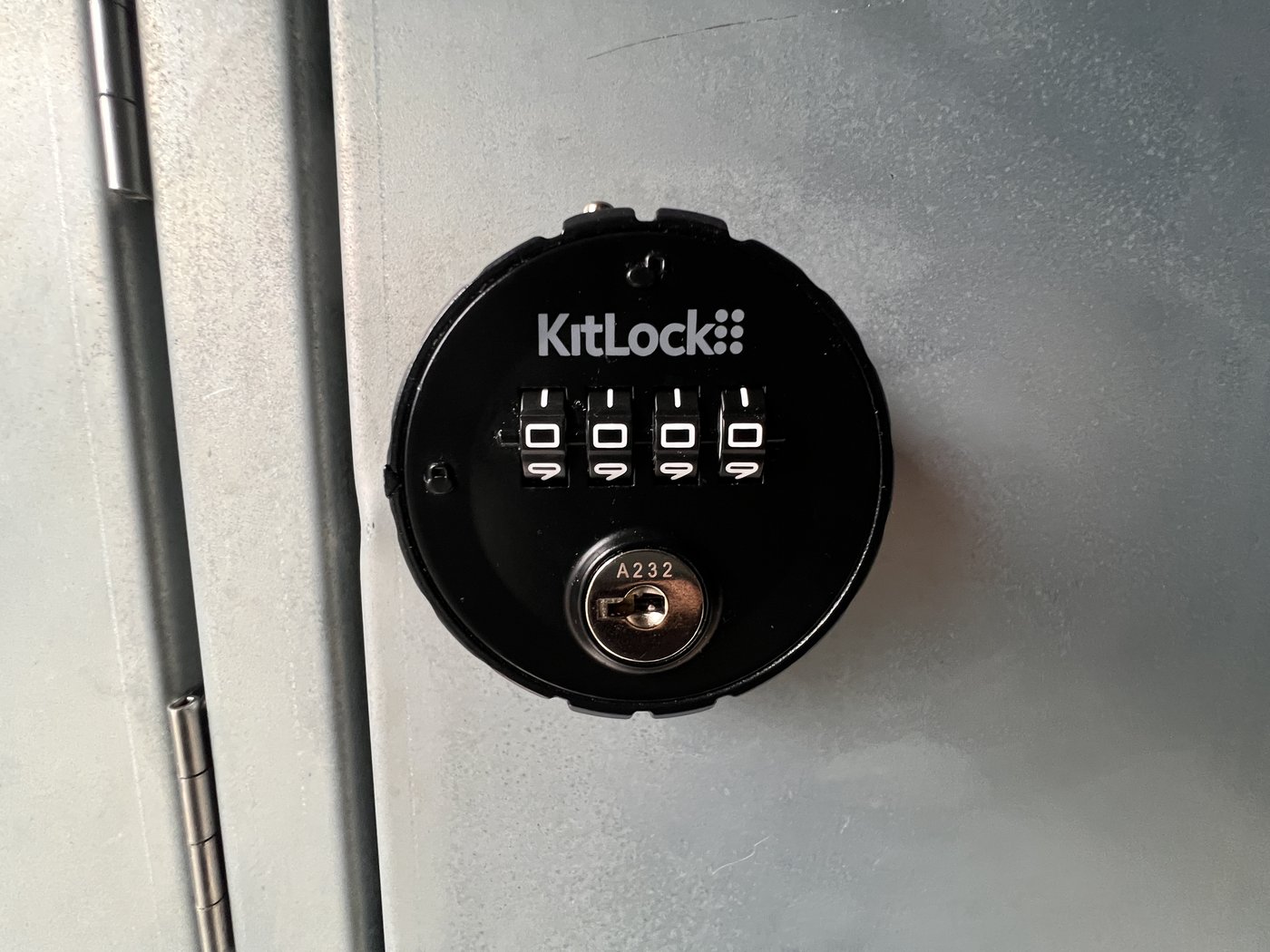 Fig. 18 — KitLock 4-digit combination lock on a charging compartment door. The lock accepts a user-set 4-digit code and includes a key override cylinder (code A232 shown here)