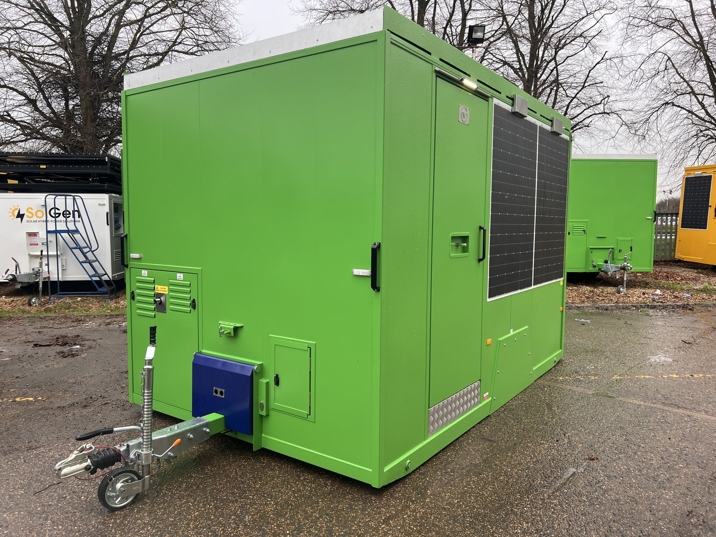 Fig. 3 — Front left view with the unit deployed: anti-vandal cover lowered over the tow hitch area, access door open, jockey wheel retracted to the side